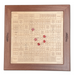 Ludo board game with wooden frame and red dice on a white background